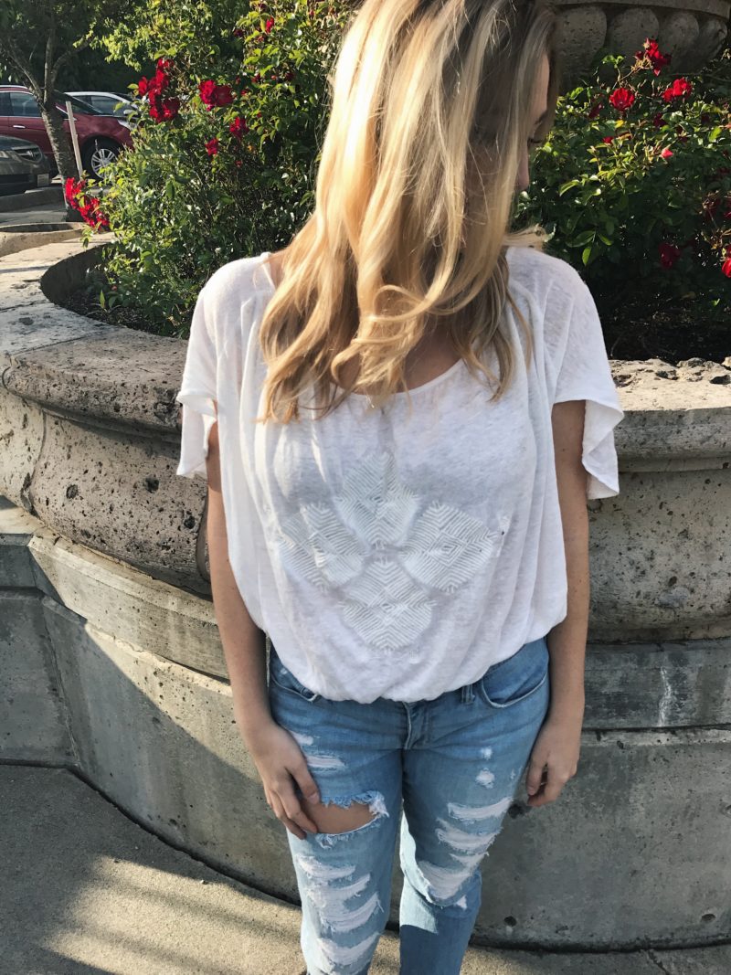 blonde hair with white free people top and ripped jeans