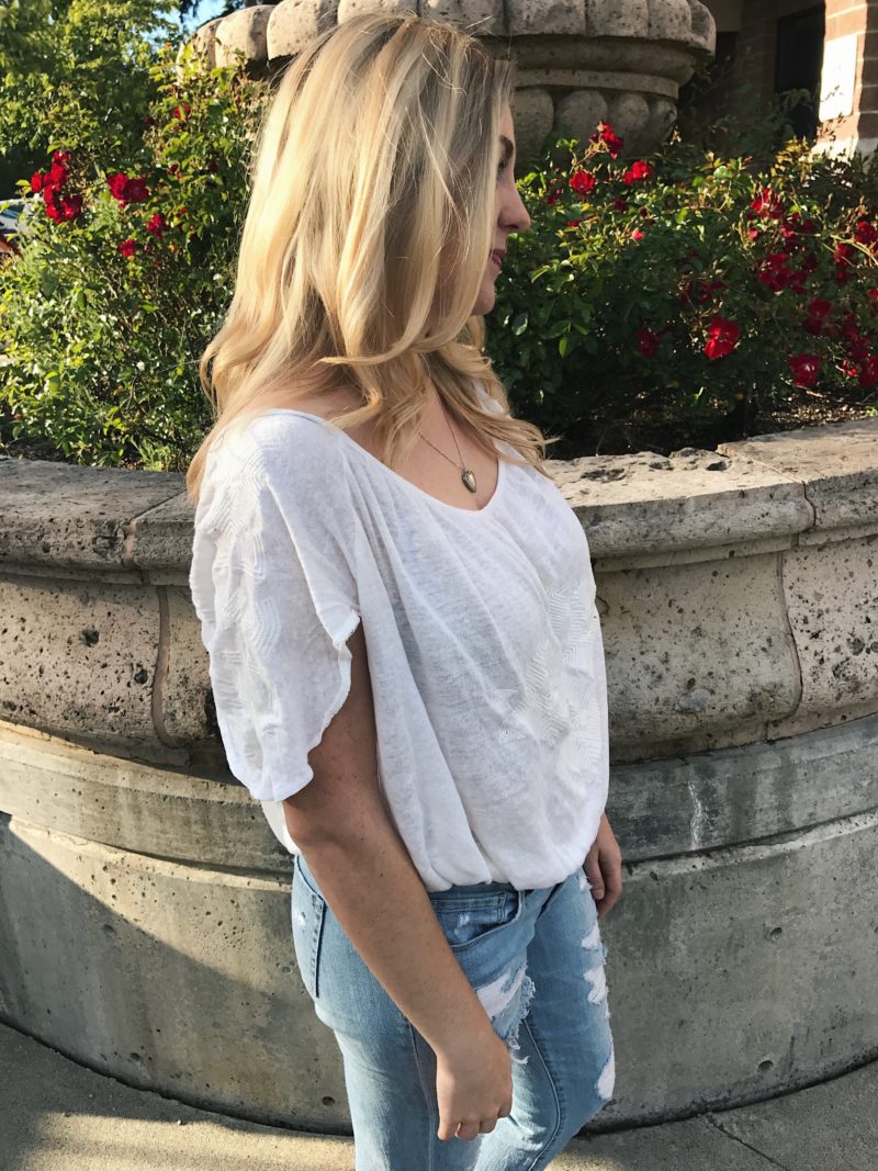 blonde hair with white free people top and ripped jeans