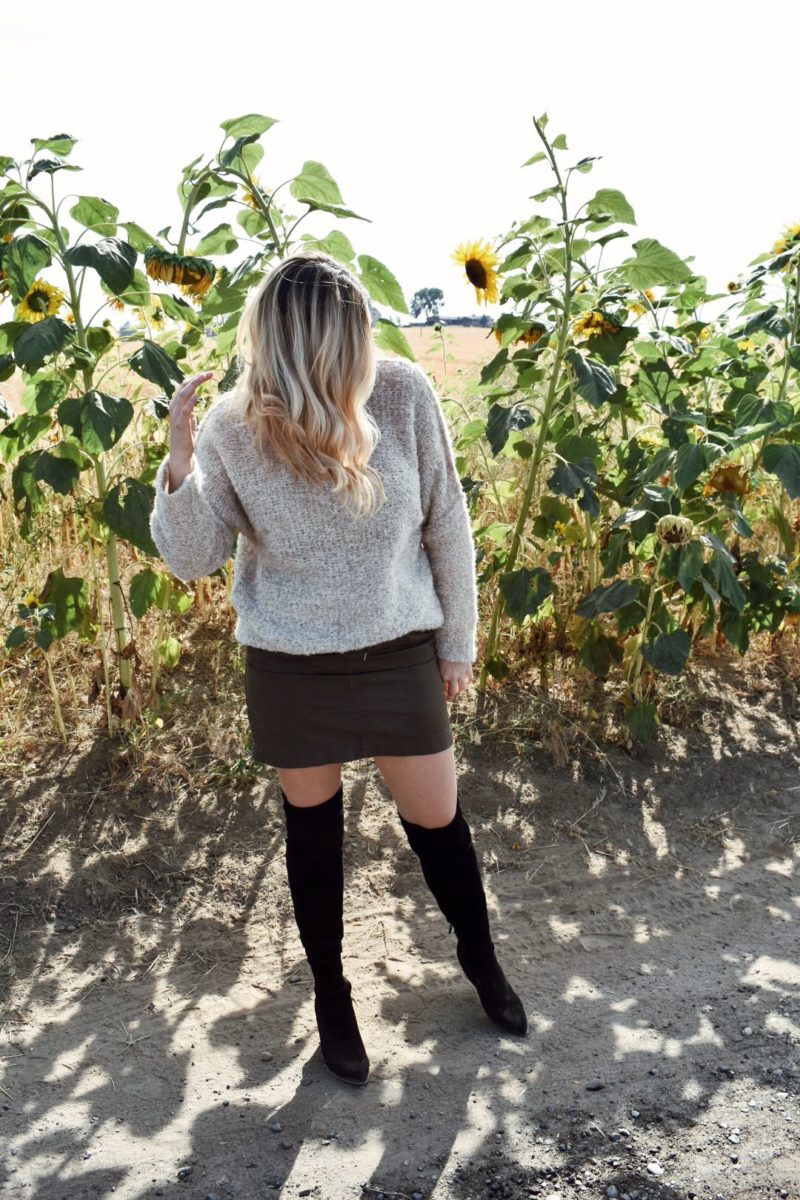 Fall outfit oversized free people sweater with over the knee boots and khaki skirt