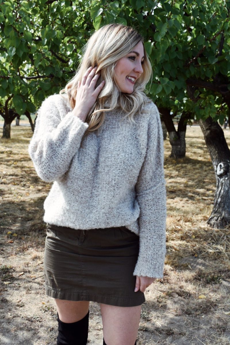 Fall outfit oversized free people sweater with over the knee boots and khaki skirt